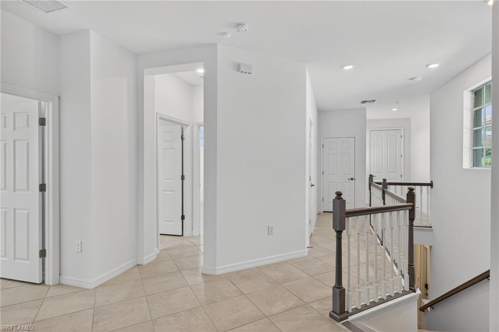 12041 Santaluz Drive, Unit 202 Fort Myers, FL 33913 - Photo 11 of 42 Hallway featuring an upstairs landing, light tile patterned floors, and recessed lighting