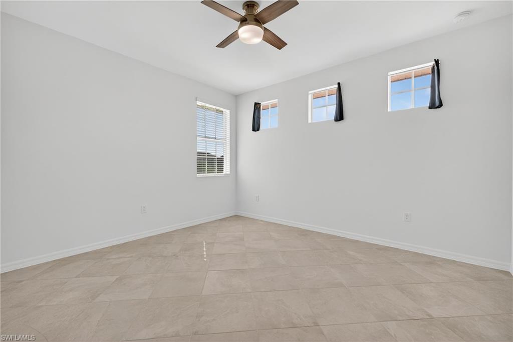 12041 Santaluz Drive, Unit 202 Fort Myers, FL 33913 - Photo 20 of 42 Unfurnished room featuring healthy amount of natural light and a ceiling fan