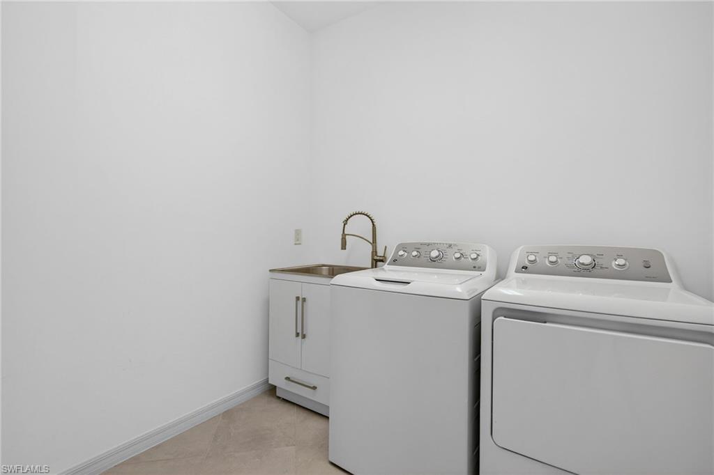 12041 Santaluz Drive, Unit 202 Fort Myers, FL 33913 - Photo 21 of 42 Washroom with independent washer and dryer and light tile patterned flooring