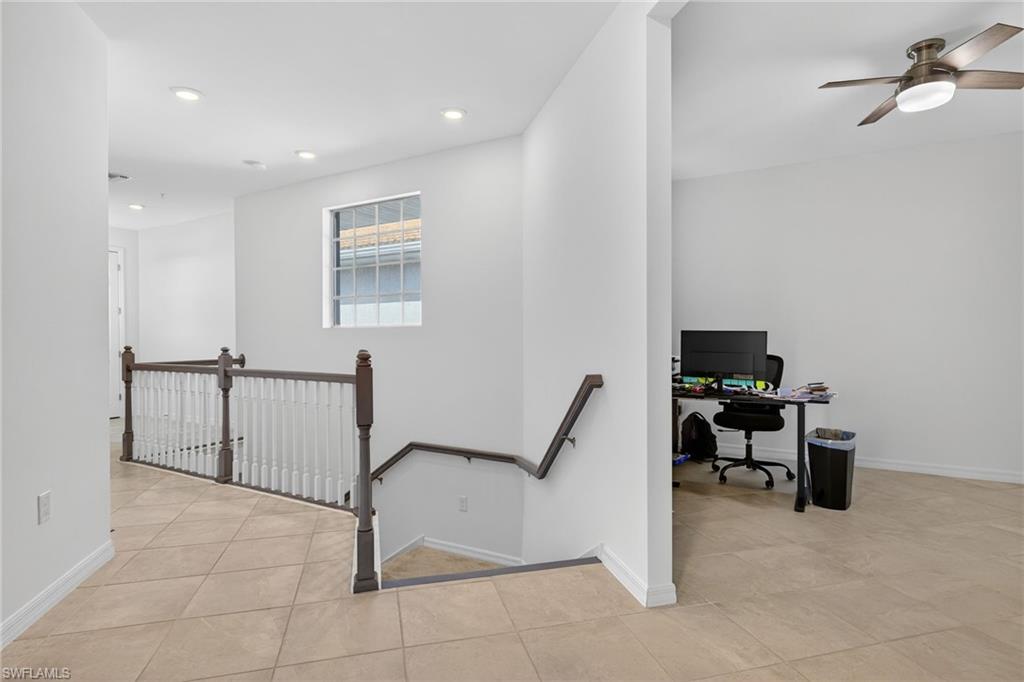 12041 Santaluz Drive, Unit 202 Fort Myers, FL 33913 - Photo 23 of 42 Hallway with an upstairs landing, light tile patterned floors, an office area, and recessed lighting