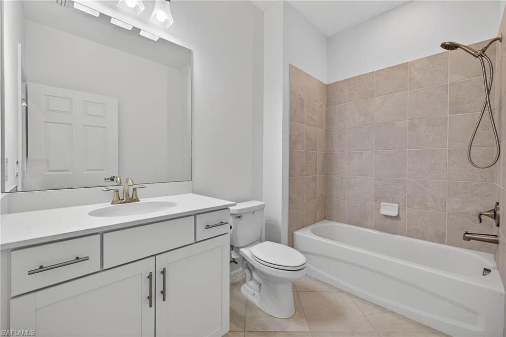 12041 Santaluz Drive, Unit 202 Fort Myers, FL 33913 - Photo 24 of 42 Bathroom two featuring bathing tub / shower combination, vanity, and light tile patterned floors