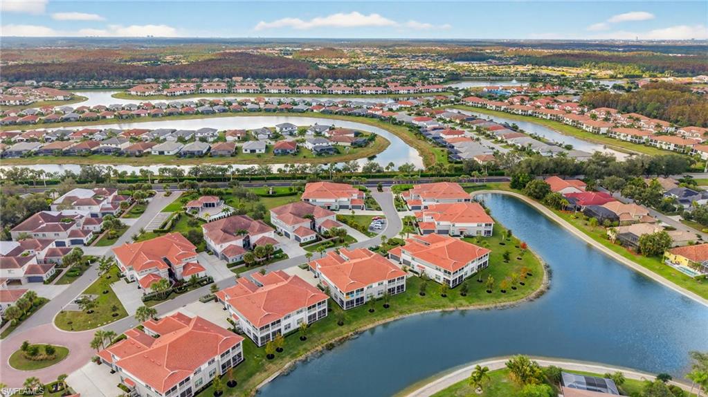 12041 Santaluz Drive, Unit 202 Fort Myers, FL 33913 - Photo 27 of 42 Aerial view of residential area featuring a nearby body of water