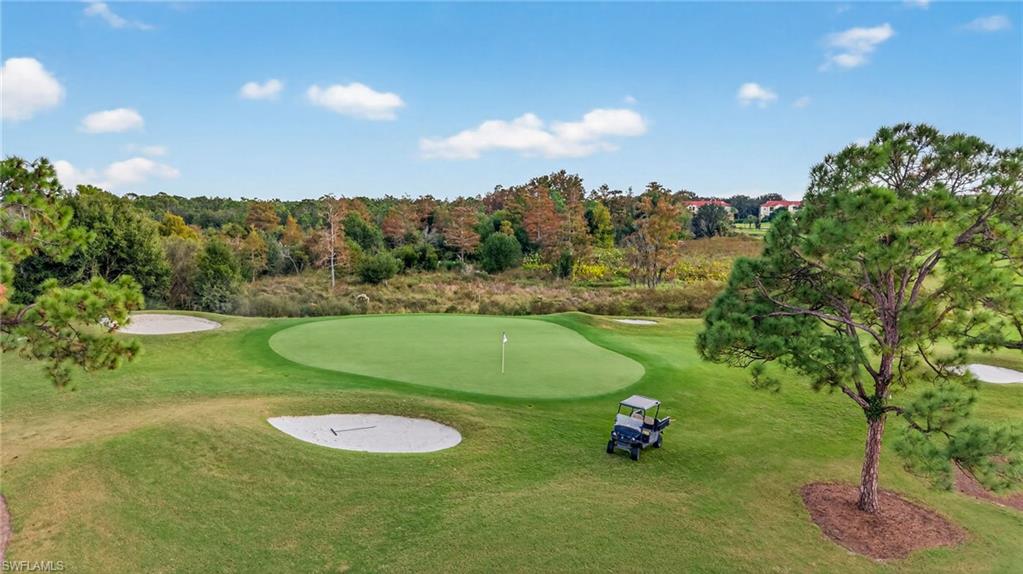 12041 Santaluz Drive, Unit 202 Fort Myers, FL 33913 - Photo 29 of 42 Surrounding community featuring view of golf course, a putting green, and a yard