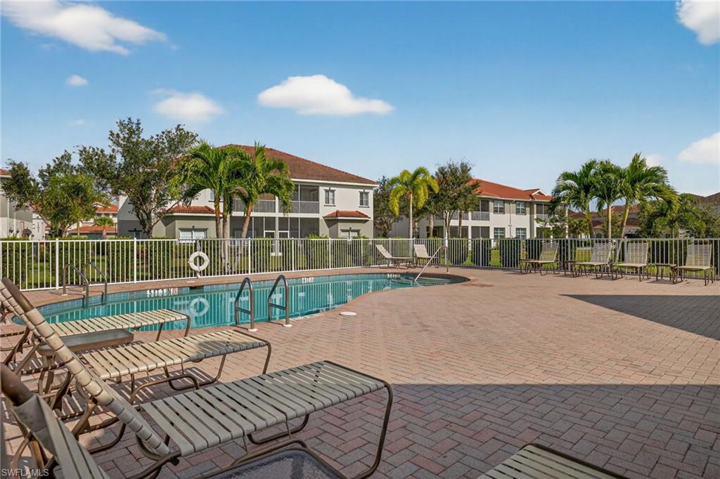 12041 Santaluz Drive, Unit 202 Fort Myers, FL 33913 - Photo 33 of 42 Community pool with a patio and a residential view