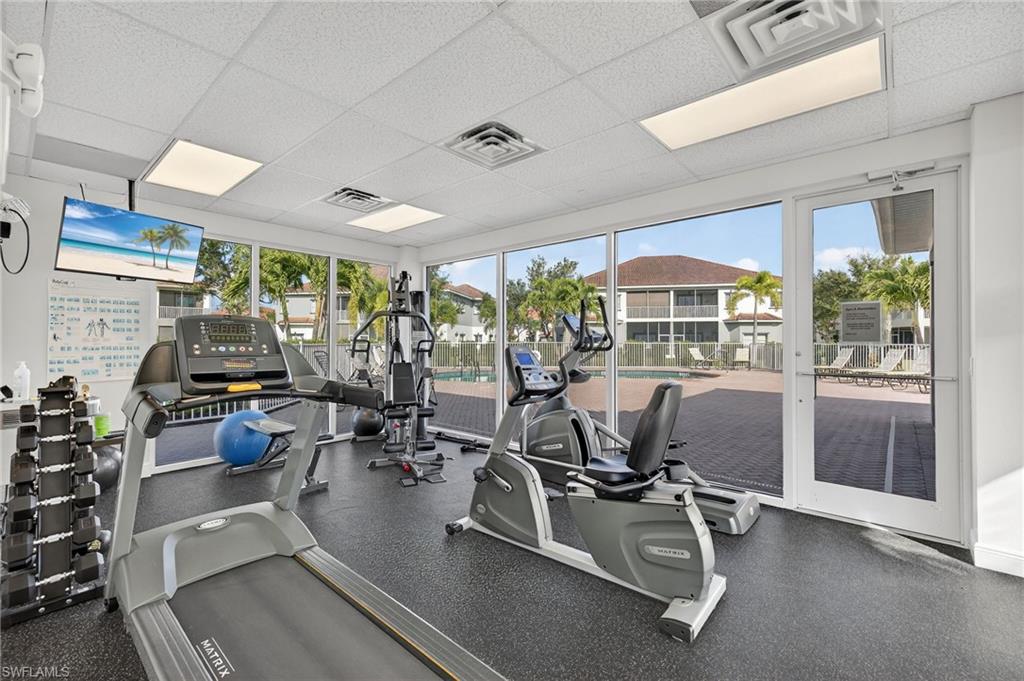12041 Santaluz Drive, Unit 202 Fort Myers, FL 33913 - Photo 34 of 42 Workout area featuring a paneled ceiling