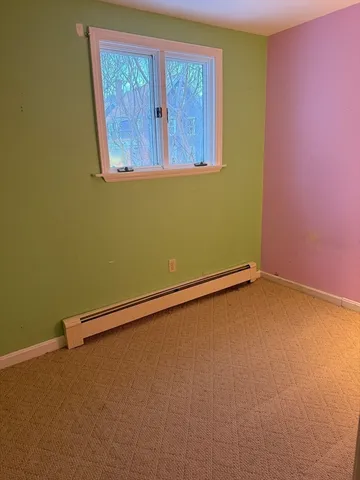 a view of a room with a window and a ceiling fan