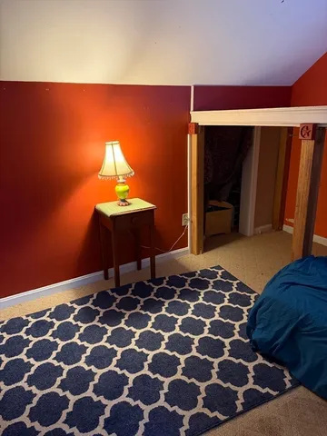 a bedroom with a bed and a mirror