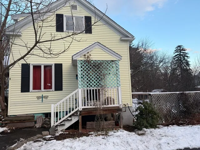 a view of a house with a yard and wooden deck