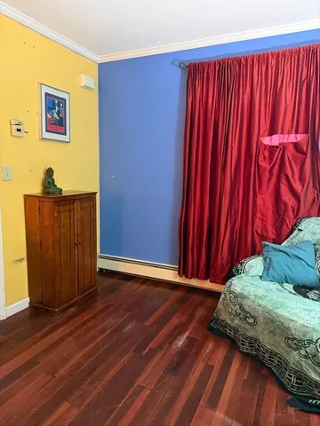 a view of a room with wooden floor and a cabinet