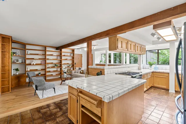 a living room with granite countertop kitchen island furniture and a large window