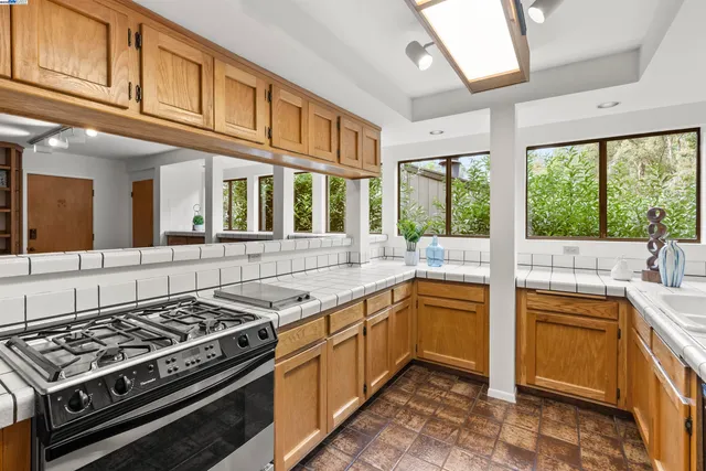 a kitchen with stainless steel appliances granite countertop a stove and a sink