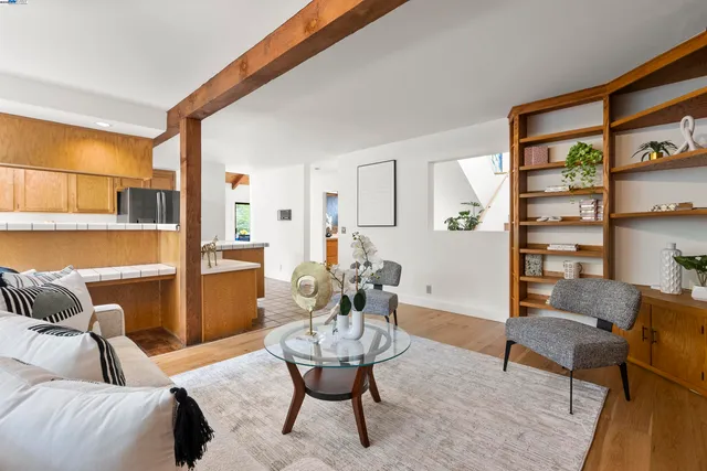 a living room with furniture and a painting on the wall