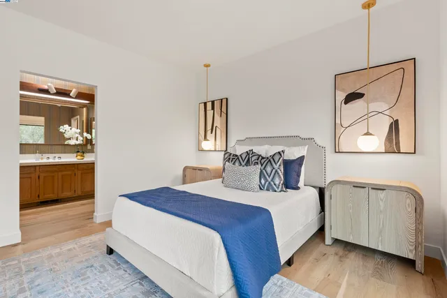 a bedroom with a bed and a view of kitchen