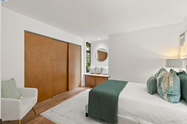 a bedroom with a bed and wooden floor