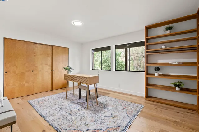 a view of a livingroom with furniture window and wooden floor