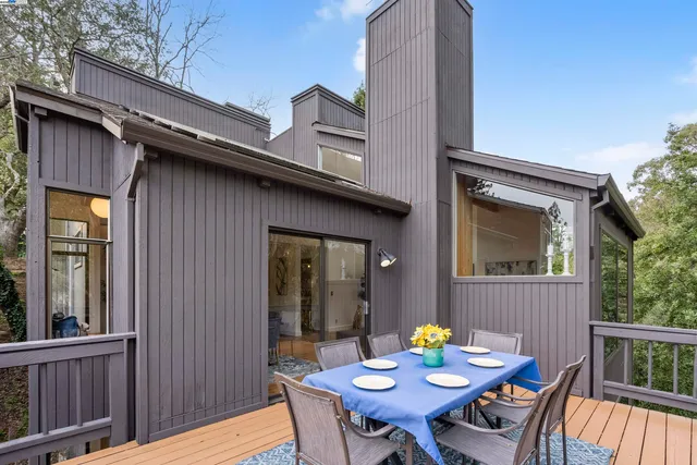 a view of a dining table and chairs on the roof deck