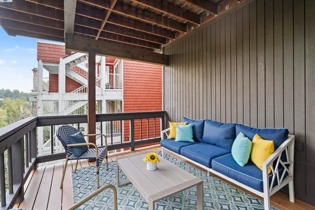 a view of sitting area in balcony with wooden floor