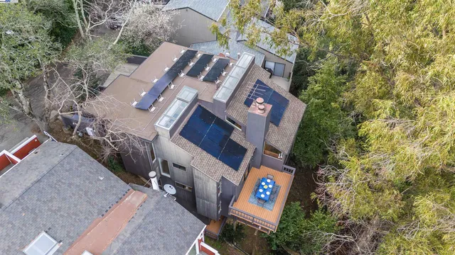 an aerial view of a house with yard and trees