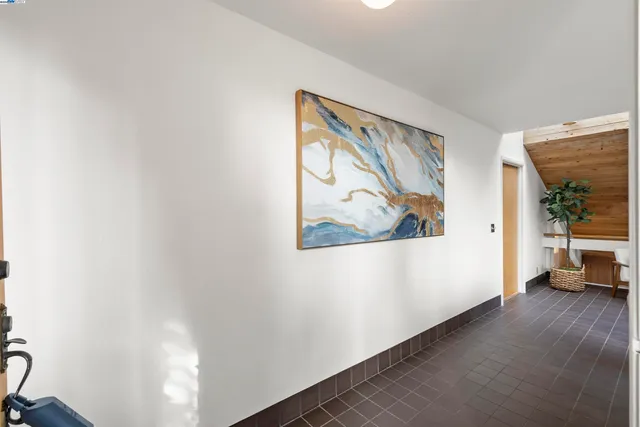 a view of a hallway with paintings on the wall