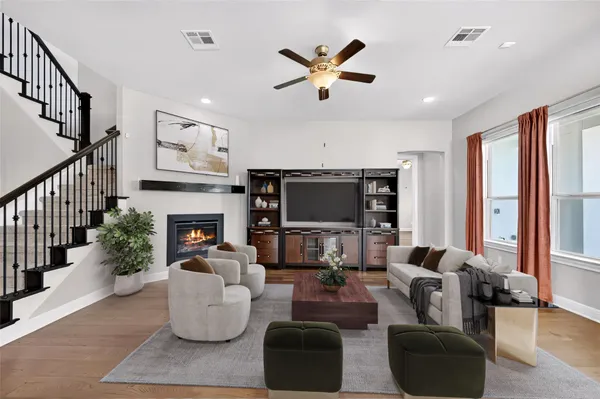 a living room with furniture a fireplace and a flat screen tv