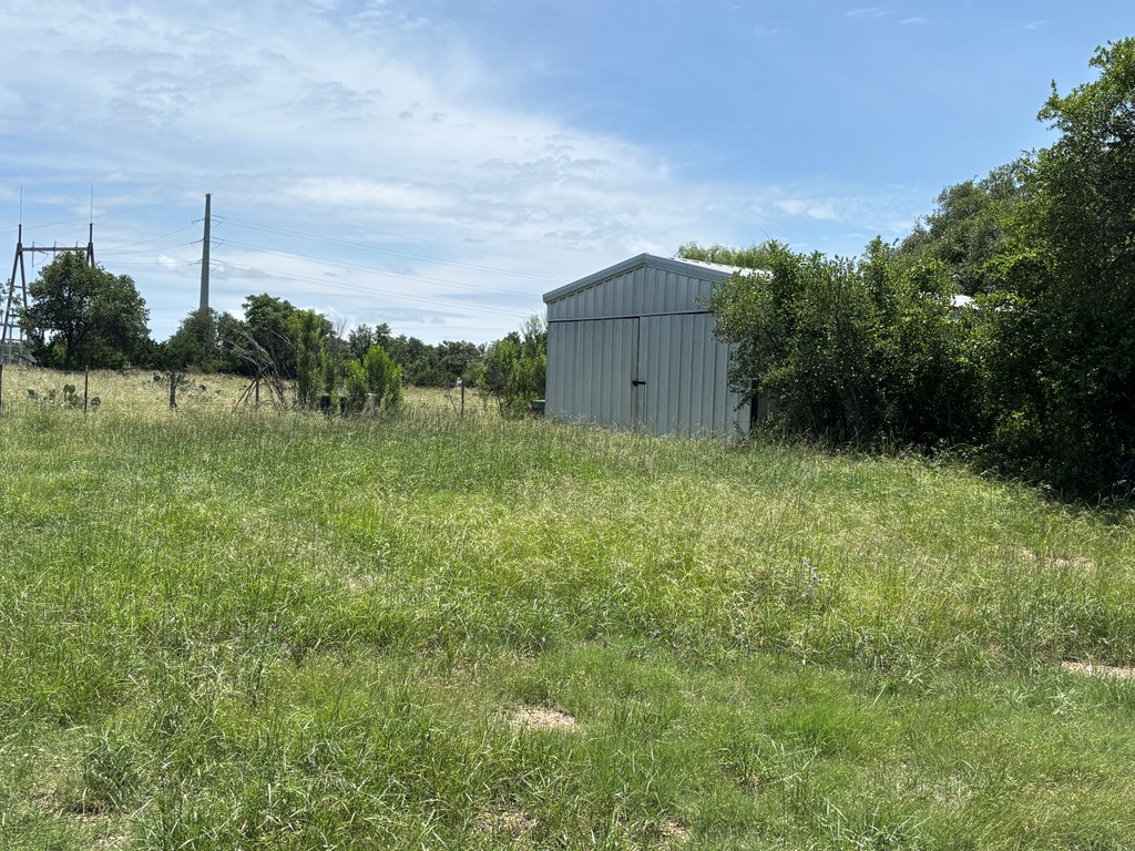 1068 North N Highway Rocksprings, TX 78880 - Photo 2 of 4 a backyard of a house with lots of green space