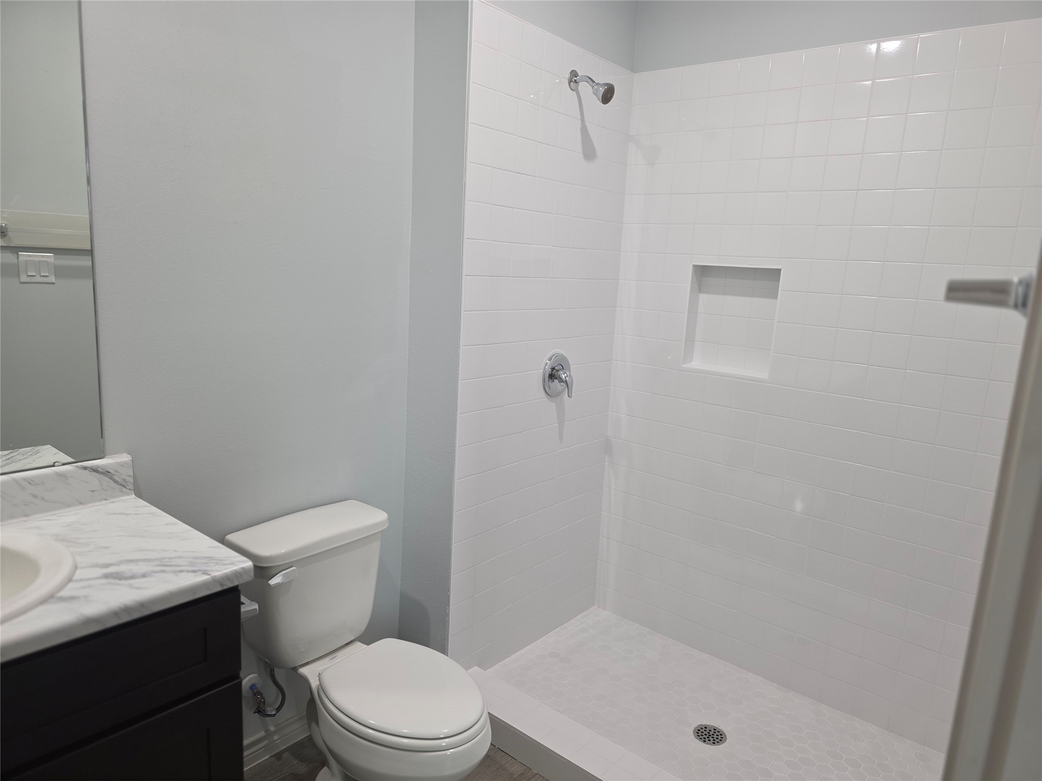 9905 Dipping Brook Street Houston, TX 77076 - Photo 5 of 7 a white toilet sitting next to a bath tub