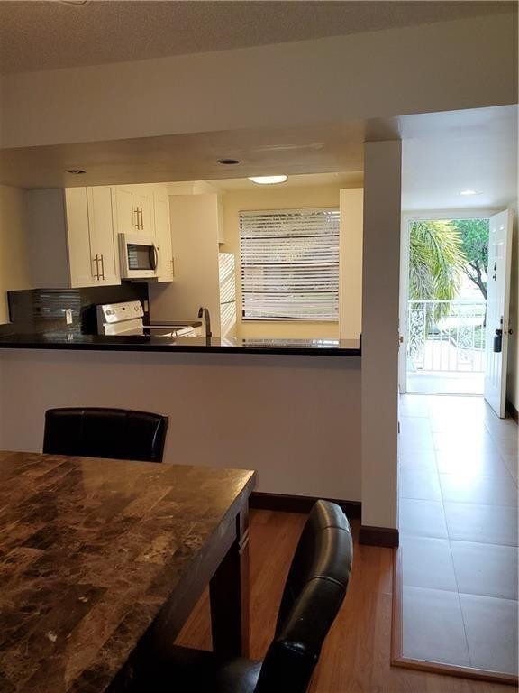 a kitchen with granite countertop sink and cabinets