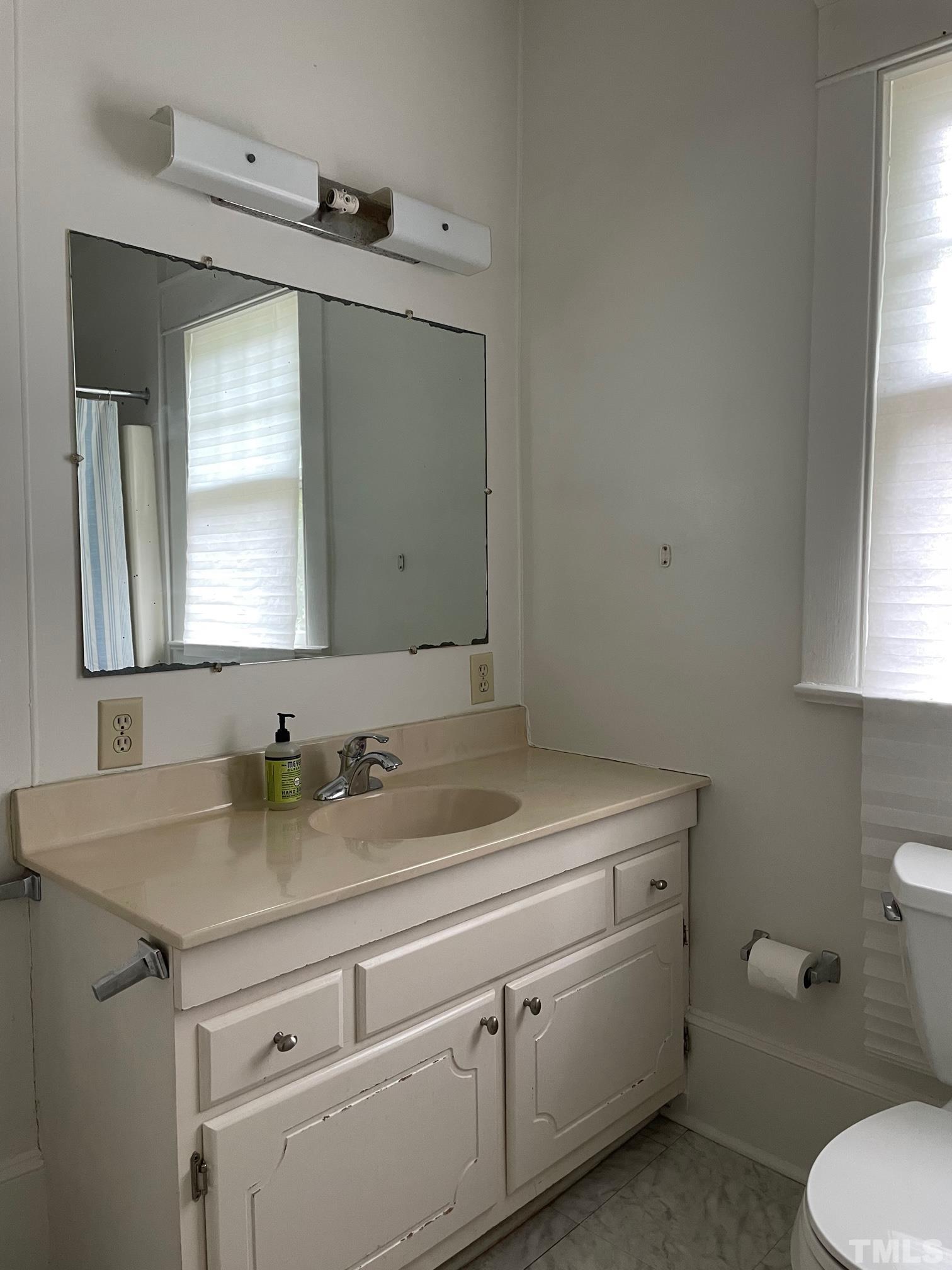 220 Glascock Street Raleigh, NC 27604 - Photo 12 of 21 a bathroom with a toilet sink and mirror