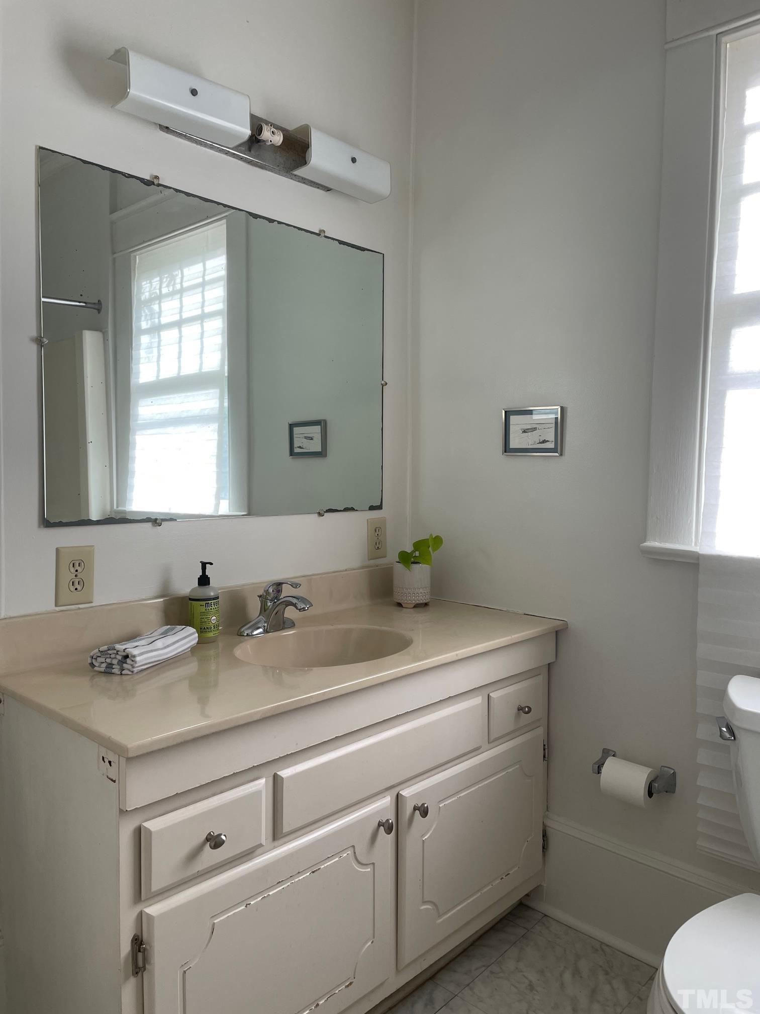 220 Glascock Street Raleigh, NC 27604 - Photo 17 of 21 a bathroom with a granite countertop toilet sink and mirror