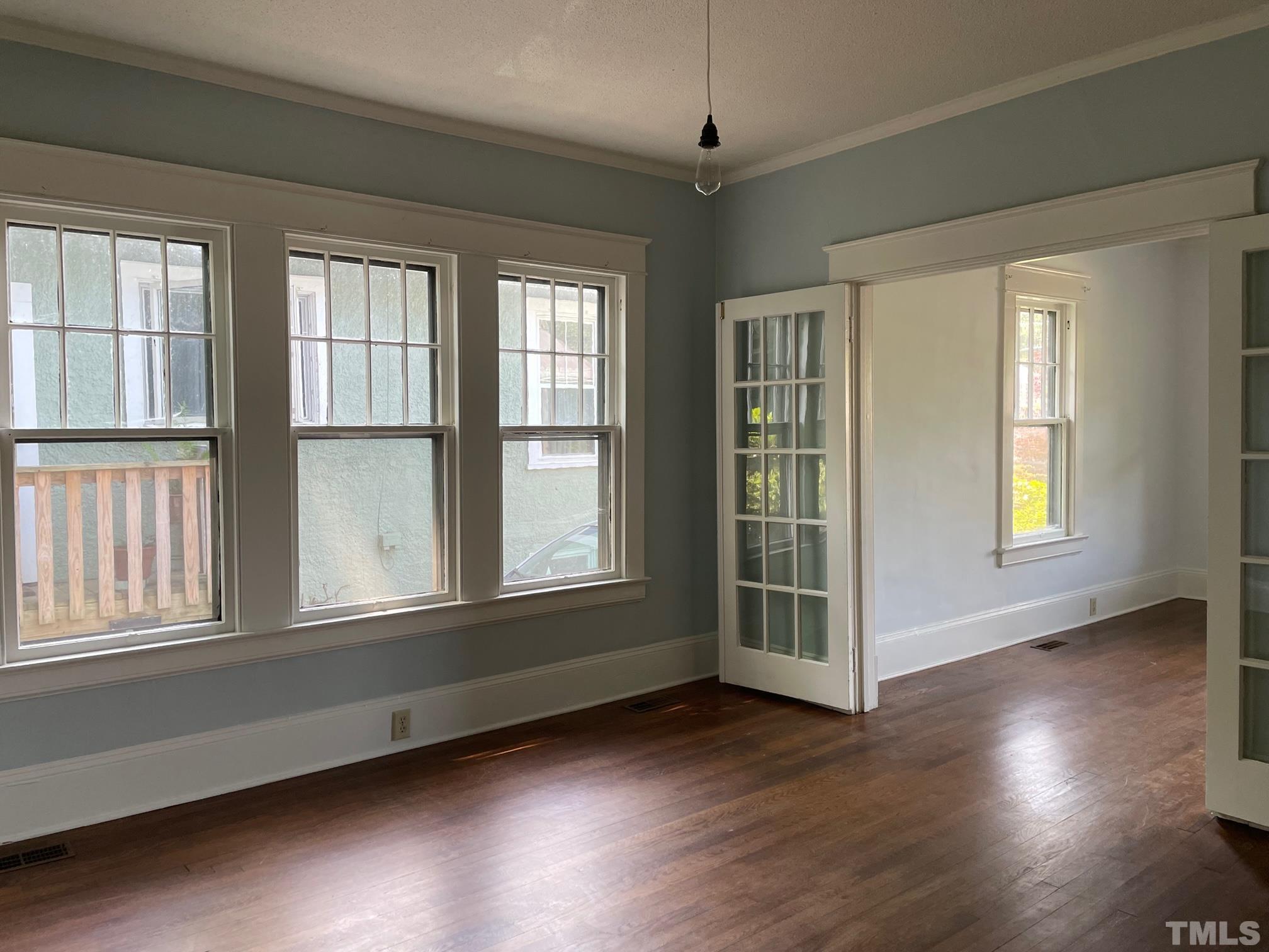 220 Glascock Street Raleigh, NC 27604 - Photo 3 of 21 a view of an empty room with wooden floor and a window