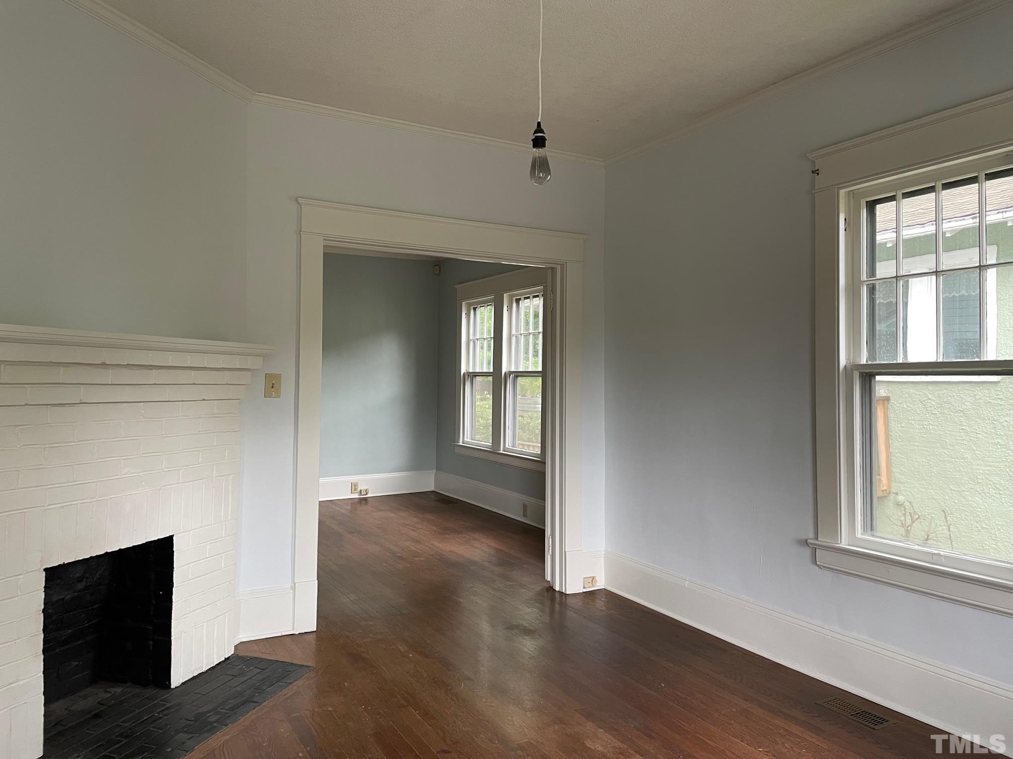 220 Glascock Street Raleigh, NC 27604 - Photo 4 of 21 an empty room with wooden floor and windows