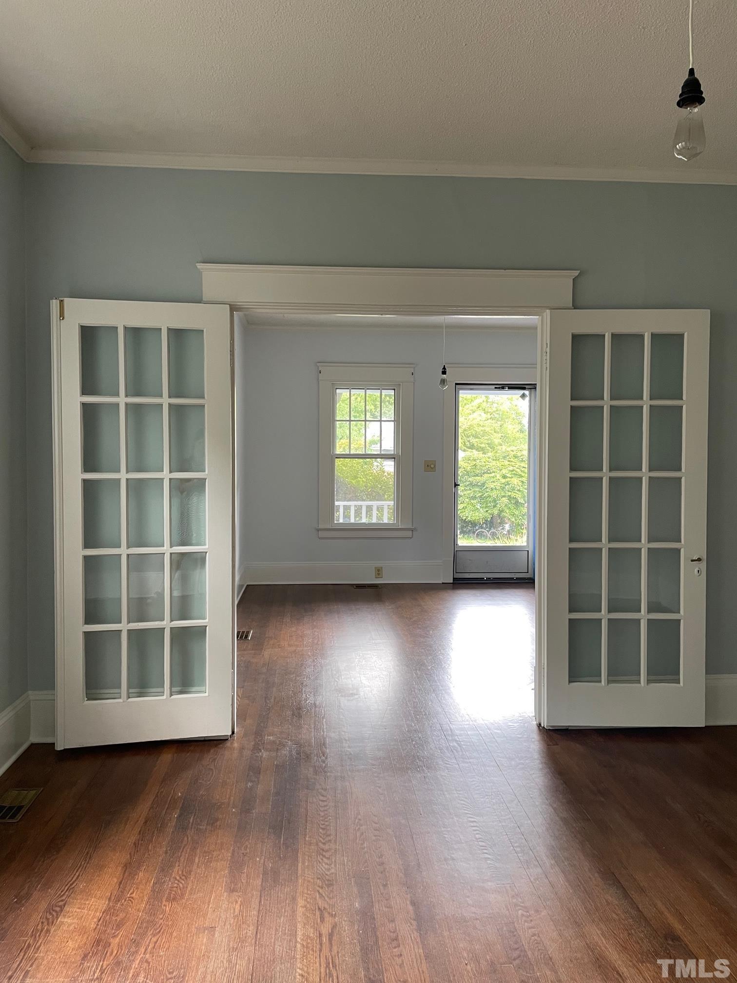 220 Glascock Street Raleigh, NC 27604 - Photo 5 of 21 an empty room with wooden floor and windows