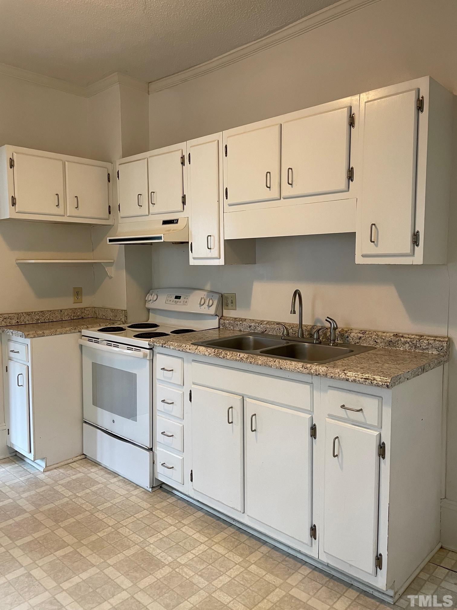 220 Glascock Street Raleigh, NC 27604 - Photo 6 of 21 a kitchen with granite countertop white cabinets and white appliances