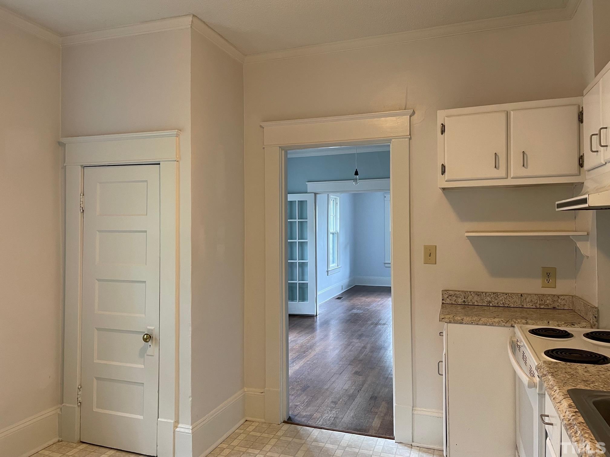 220 Glascock Street Raleigh, NC 27604 - Photo 7 of 21 a view of a kitchen with wooden floor and cabinets