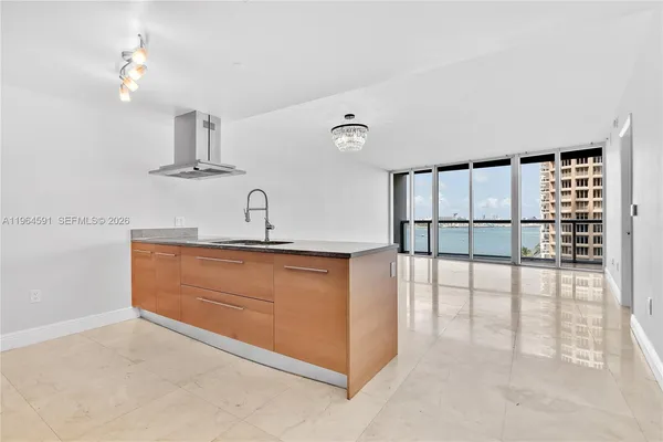 a kitchen with stainless steel appliances granite countertop a sink and a refrigerator