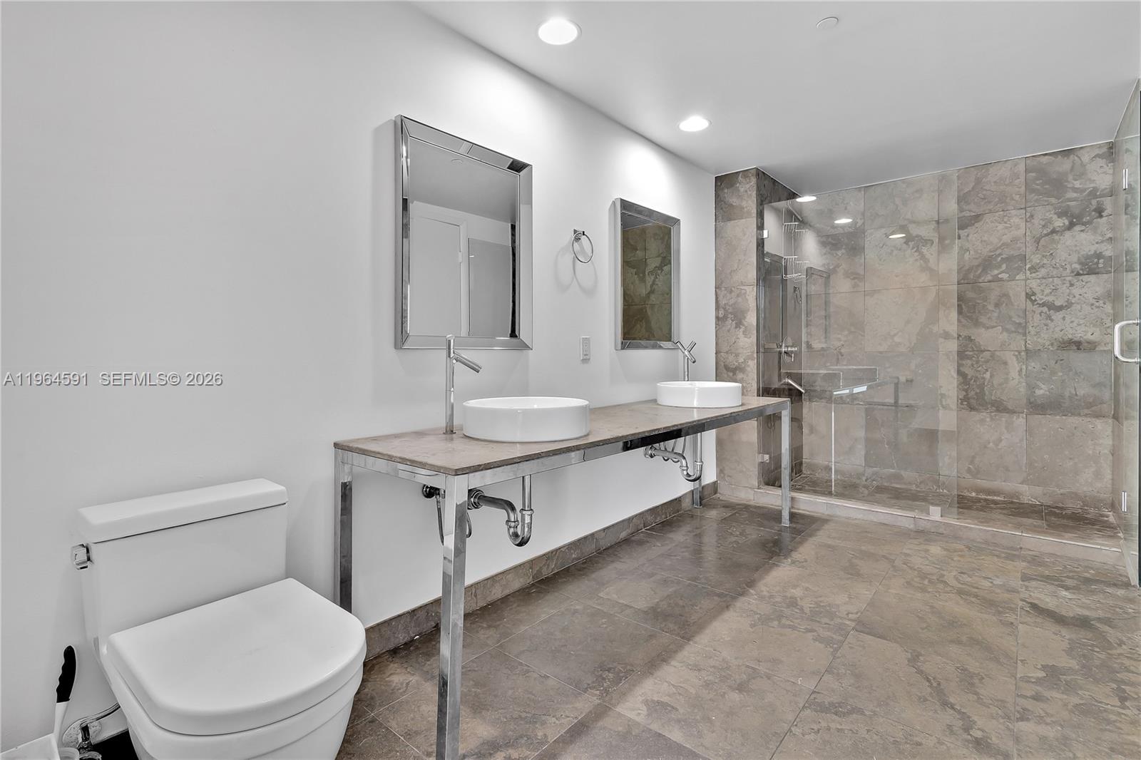 465 Brickell Avenue, Unit 917 Miami, FL 33131 - Photo 12 of 21 a bathroom with a toilet sink and shower
