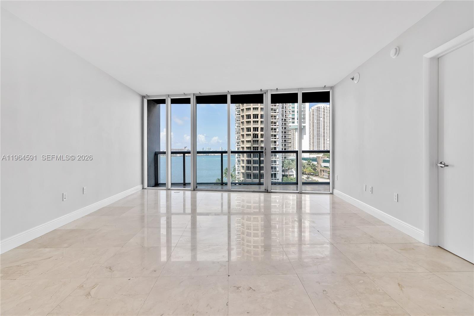465 Brickell Avenue, Unit 917 Miami, FL 33131 - Photo 7 of 21 wooden floor in an empty room with a window