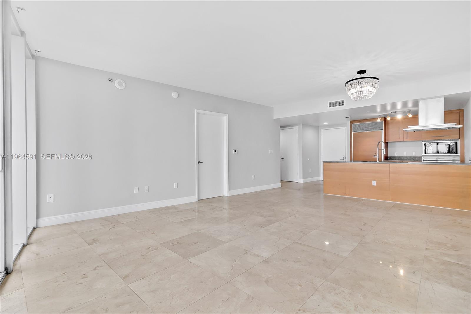 465 Brickell Avenue, Unit 917 Miami, FL 33131 - Photo 8 of 21 a view of a kitchen with furniture and an empty room