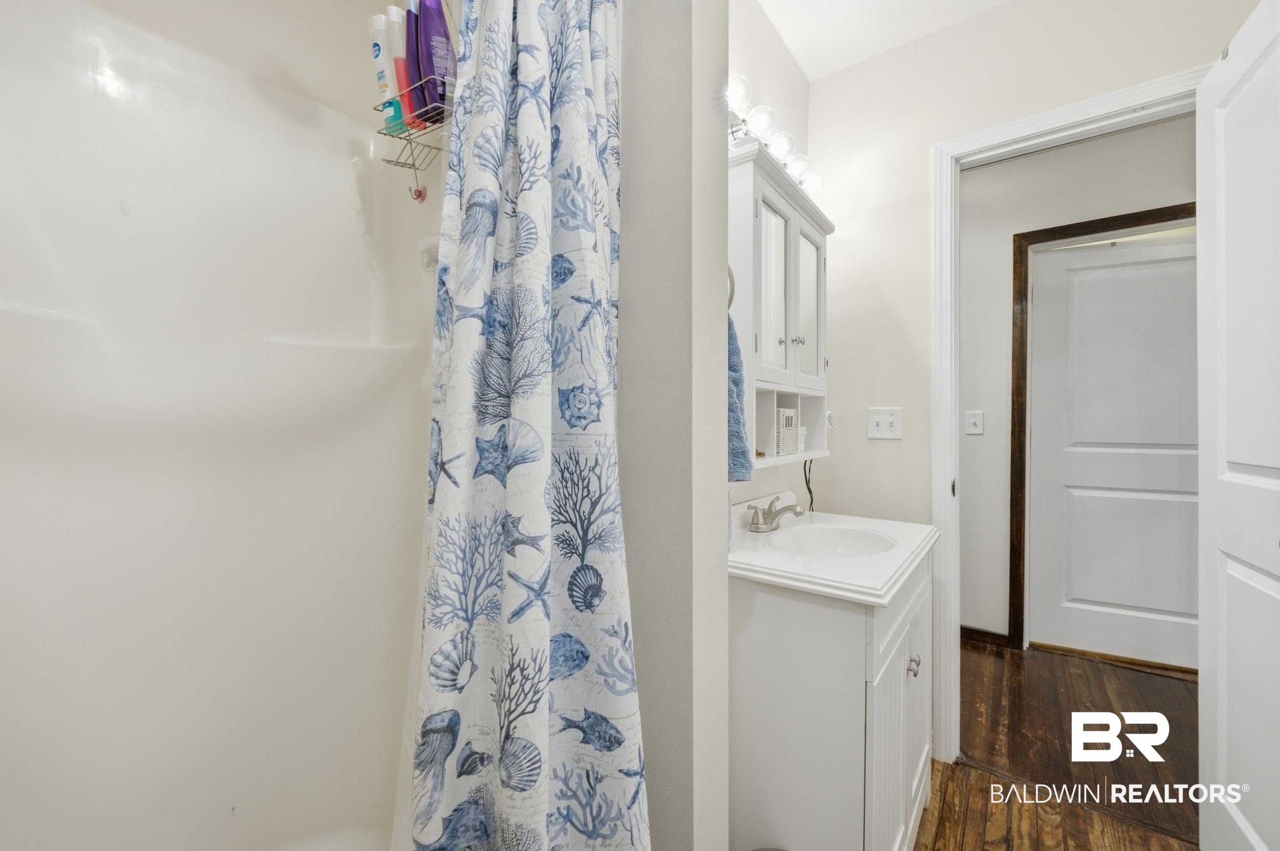 42080 Bayou Road Bay Minette, AL 36507 - Photo 20 of 43 Bathroom featuring a white vanity with an integrated sink, polished chrome faucet, and overhead vanity lighting