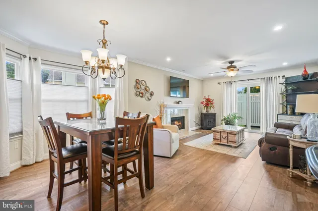 a view of a dining room with furniture wooden floor and chandelier