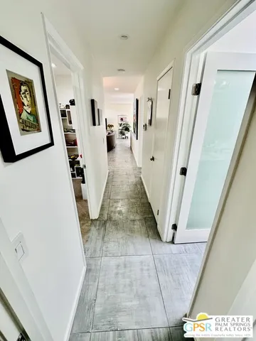 a view of a chairs and fire pit in the patio next to a yard