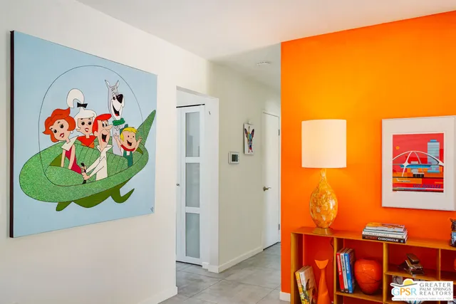 a large white kitchen with a large window and stainless steel appliances