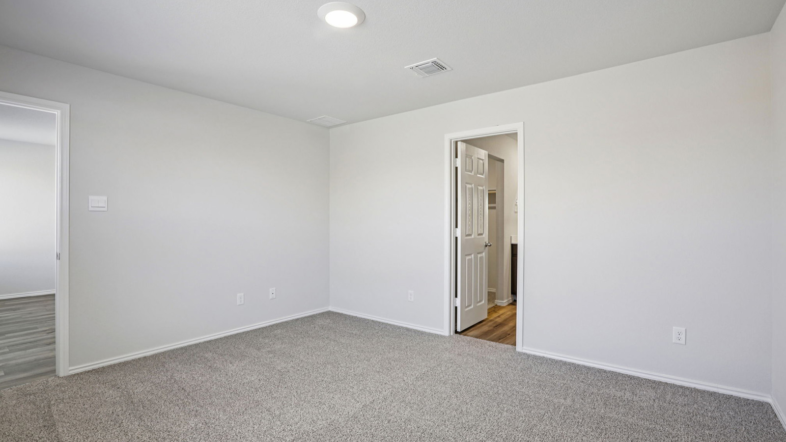 156 Wyatt Way Jarrell, TX 76537 - Photo 17 of 30 Spacious room featuring neutral carpeting, white baseboards, and light gray walls