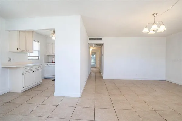 a view of a kitchen with white cabinets