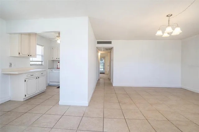 a view of a kitchen with white cabinets