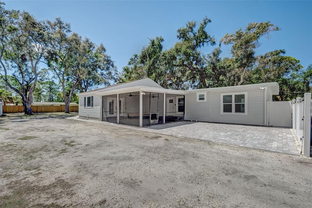 a view of a house with a yard and potted plants