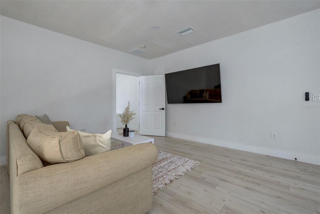 3030 Ashton Road Sarasota, FL 34231 - Photo 12 of 41 a living room with furniture and a flat screen tv