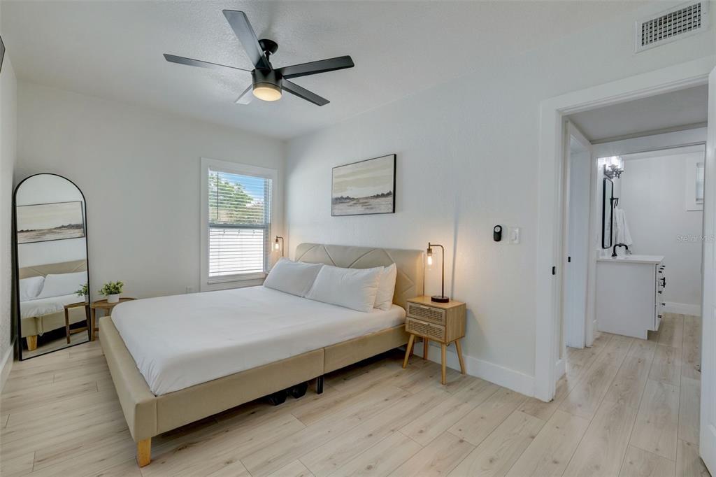 3030 Ashton Road Sarasota, FL 34231 - Photo 19 of 41 a bedroom with a bed and a chandelier