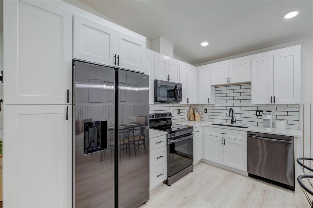 3030 Ashton Road Sarasota, FL 34231 - Photo 2 of 41 a kitchen with stainless steel appliances a sink stove refrigerator and cabinets