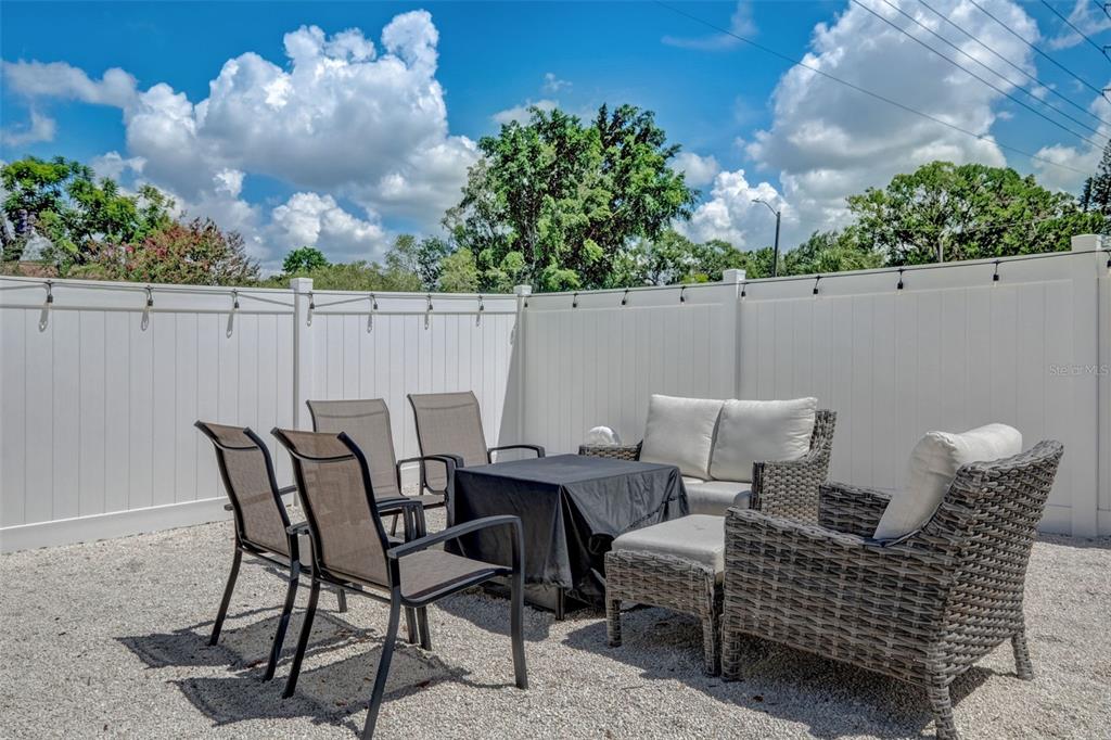 3030 Ashton Road Sarasota, FL 34231 - Photo 29 of 41 a view of a chairs and table in the back yard of the house